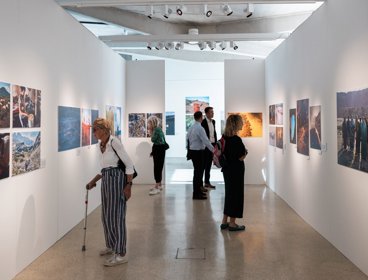 People at photography exhibition at the royal geographical society.