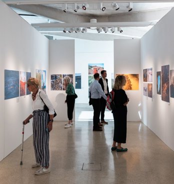 People at photography exhibition at the royal geographical society.