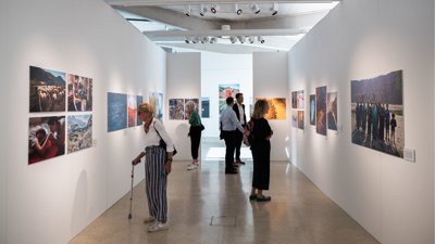 People at photography exhibition at the royal geographical society.