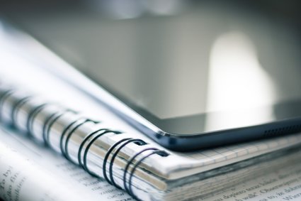 Tablet or phone on top of a notebook