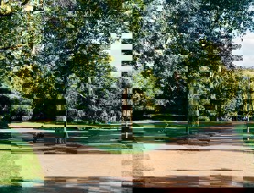 Parkland with trees, pathways and bench