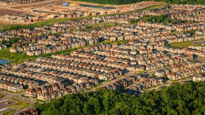 Aerial view of a new build housing estate showing rows of houses with green space.