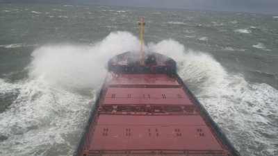MV Odin at sea with crashing waves.