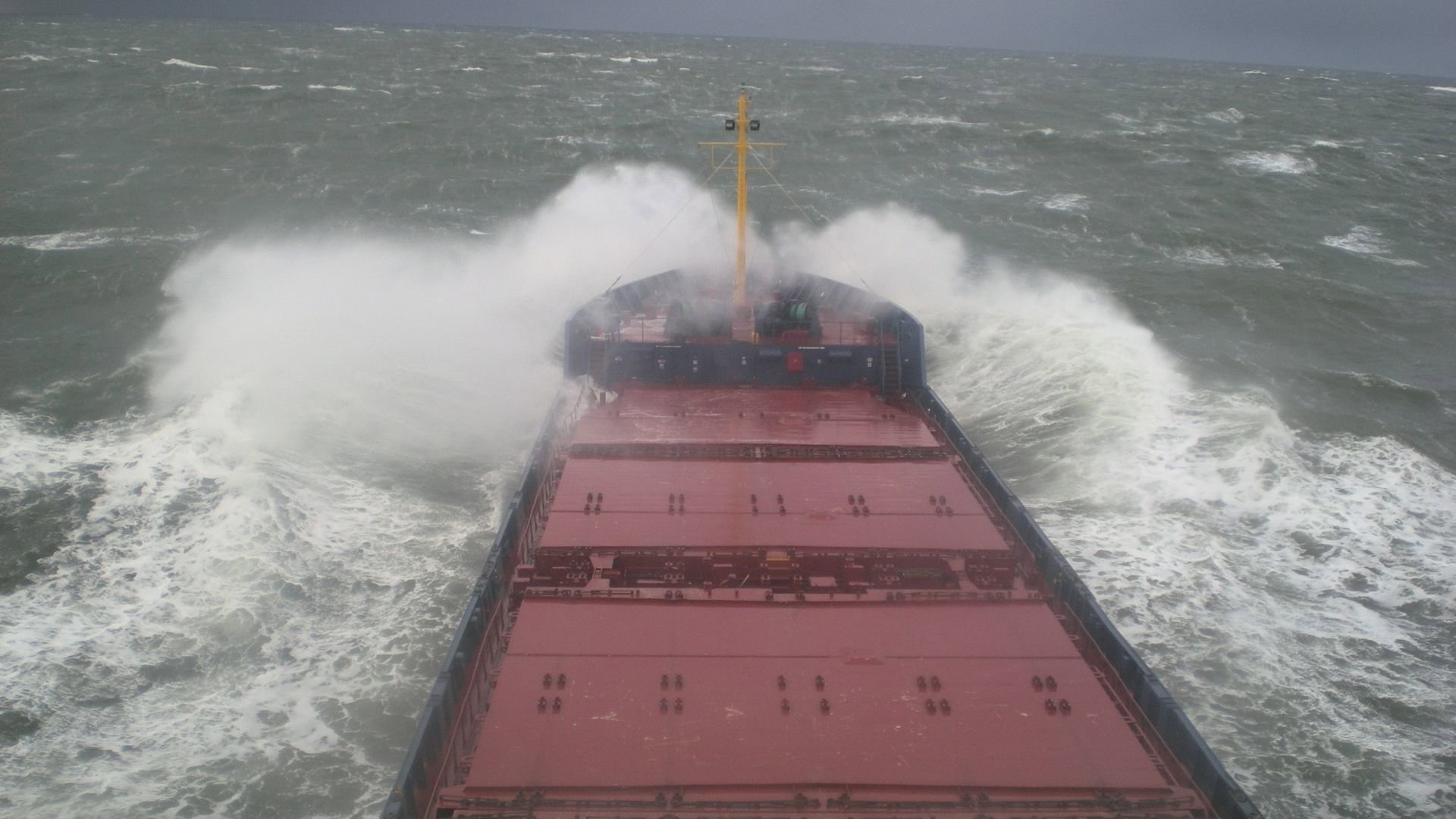 MV Odin at sea with crashing waves.