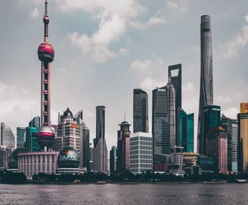 A view of a Chinese city, showing skyscrapers and modern buildings on the banks of a river