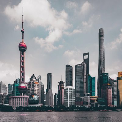 A view of a Chinese city, showing skyscrapers and modern buildings on the banks of a river
