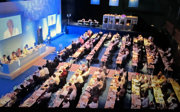 A large group of people attending an official meeting.