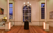 A formal reception set-up in the Map Room with warm evening lighting. 