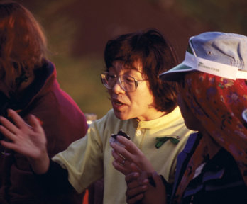 Junko Tabei in an engaged conversation with another person. 
