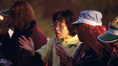Junko Tabei in an engaged conversation with another person. 