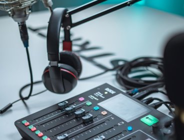 Mixing table, headphones and microphone in a recording studio 