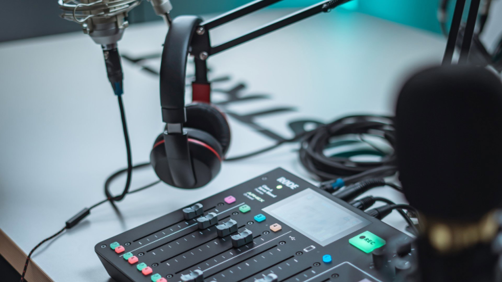 Mixing table, headphones and microphone in a recording studio 